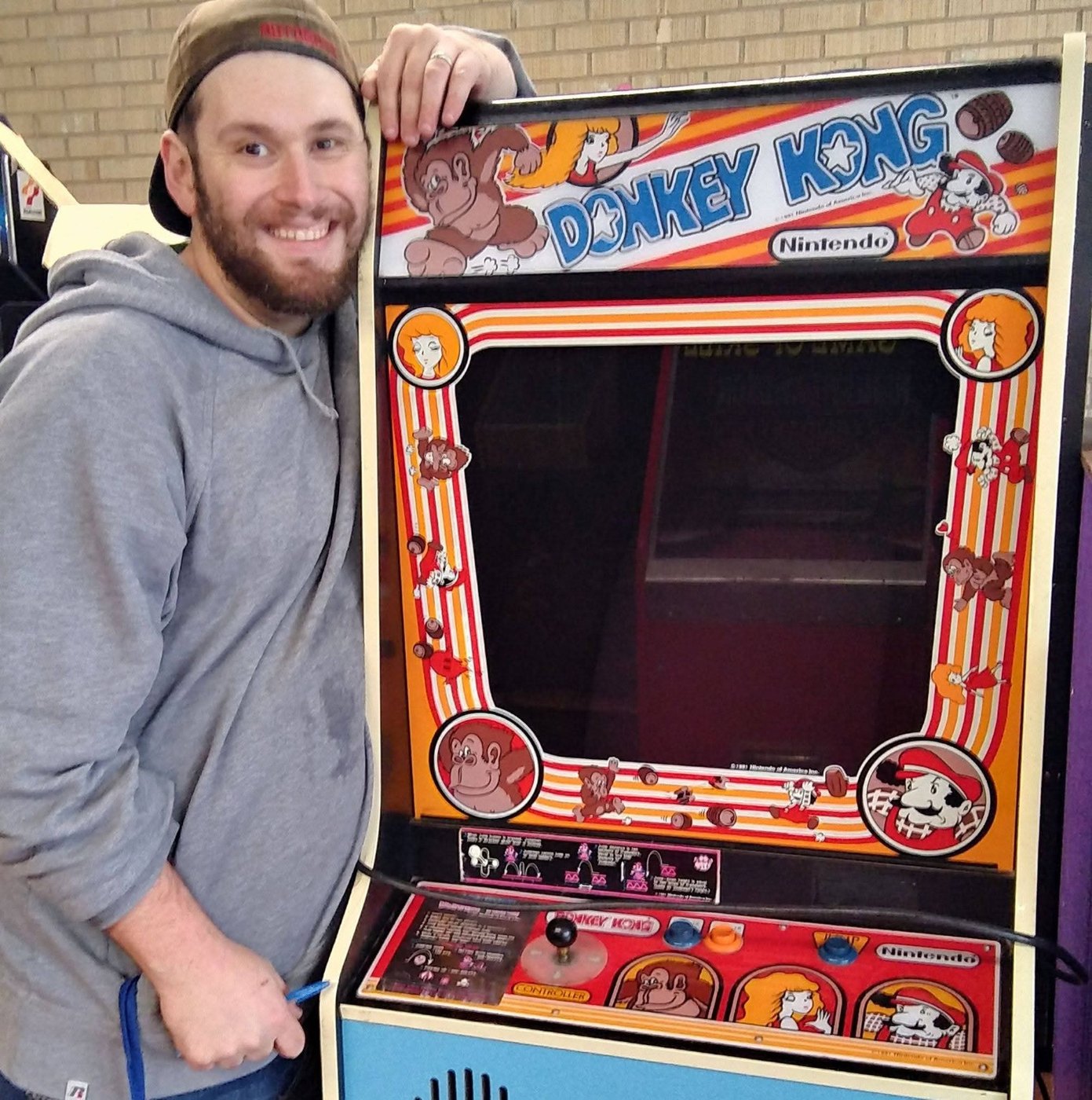 William McCollom beside a classic Donkey Kong arcade cabinet
